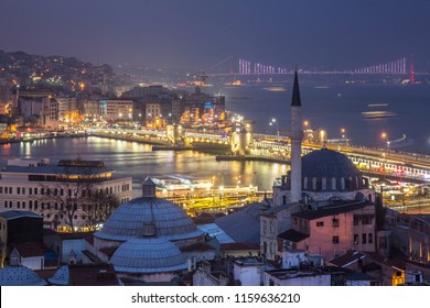 ISTAMBUL, TURKEY - MARCH 29, 2018: Night Cityscape Of Istambul, Turkey. Godlen Horn Bay , The Primary Inlet Of The Bosphorus Strait, Great Ataturk Bridge. Minaret Is On The Foreground
