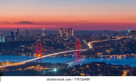 Istanbul city skyline cityscape time lapse from day to night view of bosphorus bridge (15th July Martyrs Bridge) and financial business center from Camlica hill. Traffic on the bridge and ship on