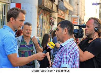 ISTANBUL - JUNE 17, 2013: Labor Unions Call 1 Day Nationwide Strike Over Crackdown At Gezi Park In Turkey. RTL TV Journalist Reports Live The Protest At Istiklal Street. Young Reporter Breaking News