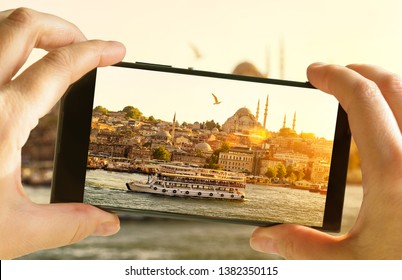 Istanbul in mobile phone photograph, Turkey. Tourist takes picture of sunny Istanbul. Eastern landscape photo on smartphone screen. Concept of photography, travel, tourism, Bosphorus and vacation. - Powered by Shutterstock