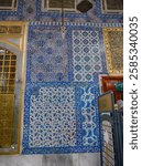 Istanbul - sep 22, 2024 - ottoman tile patterns covering building walls in istanbul, featuring intricate geometric designs with rich, vibrant ceramic coloration. , eyup mosque complex