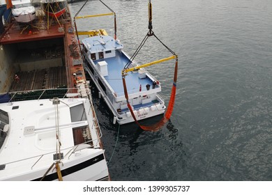 Istanbul / Turkey - 07 04 2019: Loading operation of boat on breakbulk vessel or ship underdeck heavylift gear with slings