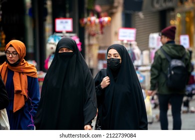 Istanbul, Turkey - 09 January 2022: Turkish woman walking at Istanbul center dressed in traditional muslim burkas
