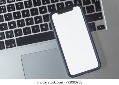 Istanbul, Turkey / 12 January 2018:New iPhone X smartphone model in close up.Newest white Apple iPhone X mobile phone device on laptop.