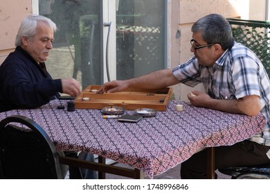 Istanbul Turkey 12/10/2019 Men Sitting In The Street Playing Games, Backgammon And Cards