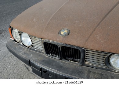 ISTANBUL, TURKEY - APRIL 30, 2022:  Slightly Rusty Destroyed BMW 5 Sedan Car. Black Metallic Color BMW 5-Series 525i E34, Luxury Old 90s Car.