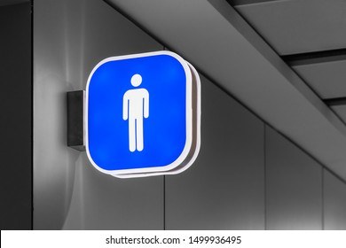 ISTANBUL, Turkey August 2019: International Airport Restroom Sign For Man Hanging On The Wall, Pictogram In Blue And White, Background In Black And White