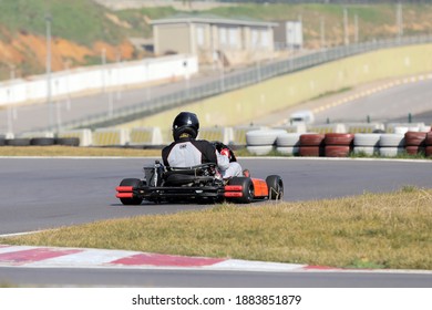 Istanbul, Turkey -August 5 2019 : Driver In Gear, Gloves And Helmet Drives A Racing Car. Go Kart In Action.