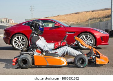 Istanbul, Turkey -August 5 2019 : Driver In Gear, Gloves And Helmet Drives A Racing Car. Go Kart In Action.