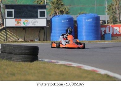 Istanbul, Turkey -August 5 2019 : Driver In Gear, Gloves And Helmet Drives A Racing Car. Go Kart In Action.