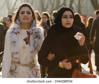 Istanbul, Turkey, December 1, 2014: Selective Focus On Two Arab Girls Walking Down Crowded Street In Winter
