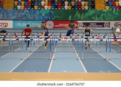 ISTANBUL, TURKEY - DECEMBER 11, 2021: Athletes running 60 metres hurdles during Turkish Athletic Federation Olympic Threshold Competitions