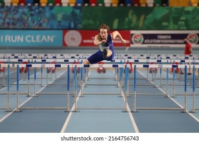 ISTANBUL, TURKEY - DECEMBER 11, 2021: Undefined athlete running 60 metres hurdles during Turkish Athletic Federation Olympic Threshold Competitions