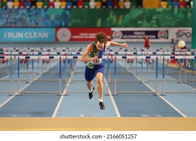 ISTANBUL, TURKEY - DECEMBER 11, 2021: Undefined athlete running 60 metres hurdles during Turkish Athletic Federation Olympic Threshold Competitions