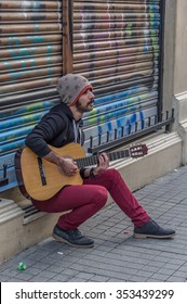 Istanbul, Turkey - December 13, 2015: Street musician performing with their guitar in Istiklal Street - Shutterstock ID 353439299