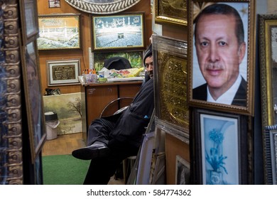 ISTANBUL, TURKEY - DECEMBER 29, 2015: Shopkeeper Selling A Huge Portrait Of The Turkish President, Recep Tayyip Erdogan
