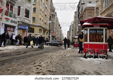 ISTANBUL, TURKEY - December 31, 2015: Snowy day in Taksim, Beyoglu. Nostalgic tram in Istiklal Street. Taksim Istiklal Street is a popular destination in Istanbul, Turkey.
