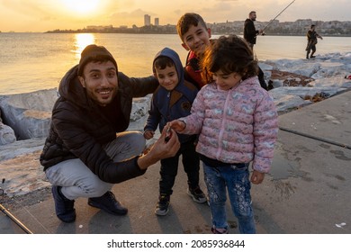 Istanbul Turkey; Family Fishing At Sunset On Samatya Beach. Happy Kids. 15 November 2021 