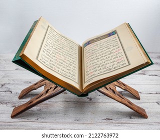 Istanbul, Turkey - February 11, 2022; Holy Quran and prayer on stand. Open for prayers Koran, Muslim prayers on wooden floors in the mosque, dark background, space for messages.