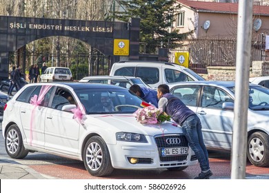 Istanbul, Turkey - February 18, 2017: Street workers who clean the car windows in traffic asking for money from a wedding car in Okmeydani district of Sisli, Istanbul, Turkey. 