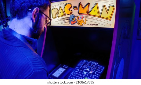 Istanbul, Turkey - February 2016: Man Playing With Pac-man Arcade Console Machine Cabinet