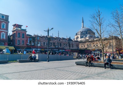 Istanbul, Turkey - February 23, 2021 - Street Photography Of People On Eminönü Square With Rüstem Pasha Mosque On A Sunny Day