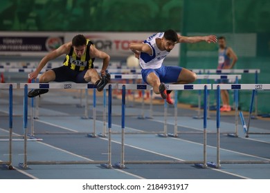 ISTANBUL, TURKEY - FEBRUARY 26, 2022: Athletes running 60 metres hurdles during Turkish Indoor Athletics Championships in Atakoy Athletics Arena