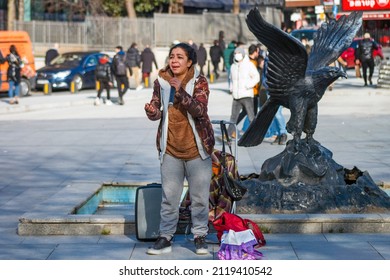 
ISTANBUL TURKEY February 5 2022: Gypsy Woman Street Performer Sings An Arabesque Song In Besiktas Square 
