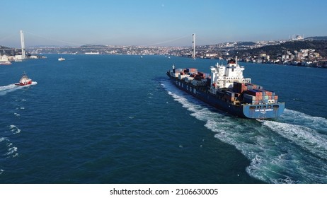 Istanbul, Turkey - January 14, 2022: Aerial Panoramic View Of A CMA CGM Container Ship Sailing Through Bosporus Strait. A Tugboat Is Seen On The Left.