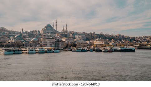 
Istanbul, Turkey - January 31, 2021 - The Pier At Eminönü On The Golden Horn With Ferries, Rüstem Pasha Mosque, And Souleymane Mosque In The Background