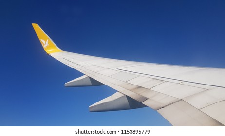 ISTANBUL, TURKEY - JULY 08, 2018: Wing of Pegasus Airlines plane during landing to Sabiha Gokcen Airport. Pegasus Airlines has 74 fleet size and 103 destinations  