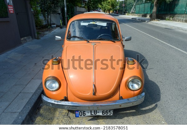 ISTANBUL, TURKEY - JULY\
13, 2022: Vintage car orange Volkswagen Beetle (Volkswagen Bug) on\
the street.