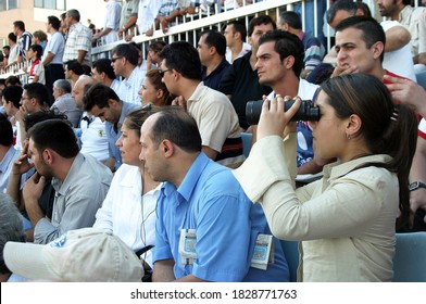 ISTANBUL, TURKEY - JULY 20: Turkish Horse Racing Fans Watching The Horse Race At The Tribune In Veliefendi Hippodrome On July 20, 2005 In Istanbul, Turkey.