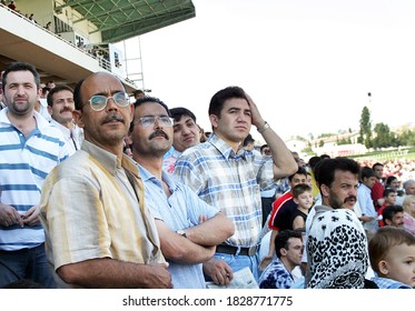 ISTANBUL, TURKEY - JULY 20: Turkish Horse Racing Fans Watching The Horse Race At The Tribune In Veliefendi Hippodrome On July 20, 2005 In Istanbul, Turkey.