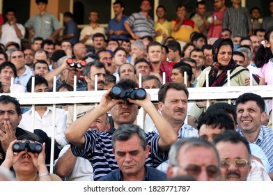 ISTANBUL, TURKEY - JULY 20: Turkish Horse Racing Fans Watching The Horse Race At The Tribune In Veliefendi Hippodrome On July 20, 2005 In Istanbul, Turkey.