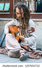 ISTANBUL, TURKEY - JUNE 02, 2014 : A Street Performer Plays A Guitar As He Sits On Istiklal Caddesi In The Taksim District Of Istanbul In Turkey.