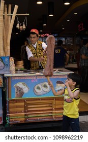 Istanbul, Turkey - June 04 2012: Half Street Performer, Half Ice-cream Vendor! The Vendor Dangled The Large Dollop Of Ice Cream So That The Kid Could Catch Some Into His Cone, In Istanbul (Turkey)