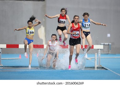 ISTANBUL, TURKEY - JUNE 12, 2021: Athletes running hurdles during Balkan U20 Athletics Championships