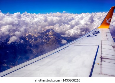 Istanbul Turkey – June 16, 2019:   Wing of Pegasus Airlines plane during landing to Sabiha Gokcen Airport. 