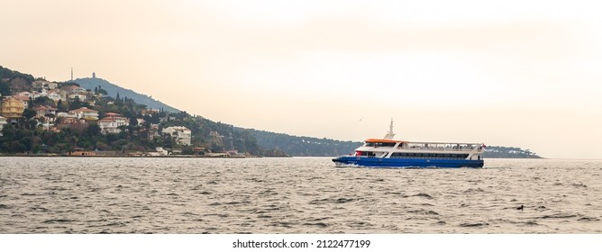 Istanbul, Turkey - March 3, 2013: Ferry Boat Crossing Buyukada Island With Houses And Green Mountains In The Back. The Island Is The Largest Of Four Islands Named Princes Islands In The Sea Of Marmara