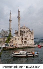 Istanbul, Turkey - May 05, 2009: Pleasure boats and view of the Ortakoy Mosque in the urban center of the city, a cloudy day