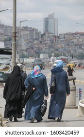 Istanbul, Turkey - May 05, 2009: Group of Muslim women walking along an avenue in the populous Dogancilar neighborhood, on the banks of the Bosphorus with blurred background