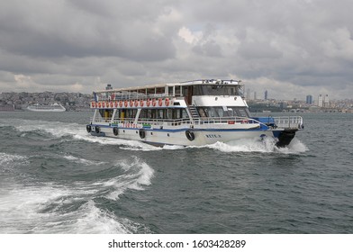 Istanbul, Turkey - May 05, 2009: Ferry boat sailing between the waters of the Bosphorus in the urban center of the city, a cloudy day