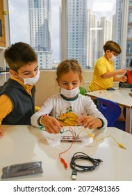 ISTANBUL, TURKEY - October 01, 2021: A Group Of Middle School Students Working On A Science Project With Wires And Electronic Devices.