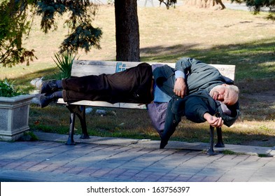 ISTANBUL TURKEY OCTOBER 3: A Homeless Man Sleeping On Bench Park On Oct 3, 2013 In Istanbul Turkey. The Absolute Poverty Line For Turkey Was US $4 Per Capita Per Day.