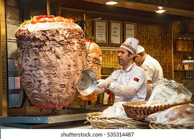 ISTANBUL, TURKEY - OCTOBER 6, 2014: A chef cutting traditional Turkish food Doner Kebab in a street food shop