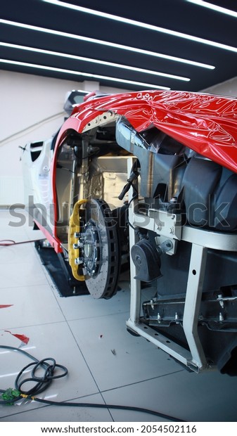 Istanbul, Turkey - October 7, 2021: Ferrari F488\
ceramic break. Close the wheel with a logo and yellow caliper of\
the carbon ceramic breaking system. High performance brake rotor\
and disc.\
