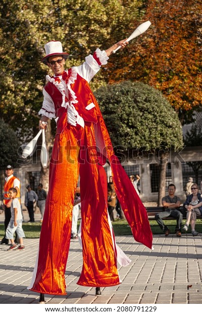 Istanbul, Turkey - SEPTEMBER 28 2012: It is a\
entertainment festival in a street of Istanbul stilts walker man in\
red juggling smiling