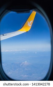 Istanbul, Turkey-may 04, 2019: International Airport Sabiha Gökçen International Airport, The Wing Of A Passenger Airliner Pegasus With A Yellow Logo Of A Horse In Flight In The Blue Sky