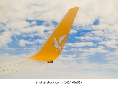 Istanbul, Turkey-may 04, 2019: International Airport Sabiha Gökçen International Airport,yellow Wing Passenger Aircraft In Flight In The Clouds, Pegasus Airline, Logo With A Horse